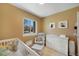 Bright Bedroom with a window, a white crib, glider, and matching dresser at 18714 E Utah Cir, Aurora, CO 80017