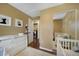 Neutral Bedroom with a changing table, artwork, and access to laundry through a door at 18714 E Utah Cir, Aurora, CO 80017