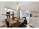Inviting dining room with breakfast nook, featuring a modern lighting fixture and wood floors at 18714 E Utah Cir, Aurora, CO 80017