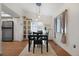 Bright dining room with modern lighting and a large window overlooking the backyard at 18714 E Utah Cir, Aurora, CO 80017