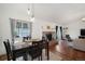 Open-concept dining room flows into the living room, showcasing hardwood floors and natural light at 18714 E Utah Cir, Aurora, CO 80017