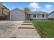 Charming single Gathering home with brick accents, well-manicured lawn, and inviting walkway at 18714 E Utah Cir, Aurora, CO 80017