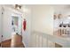 Open hallway with hardwood floors that leads to an open-concept living space at 18714 E Utah Cir, Aurora, CO 80017