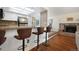 Stylish kitchen with modern bar stools, granite countertops, and convenient access to the living area at 18714 E Utah Cir, Aurora, CO 80017