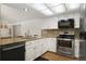 Stylish kitchen features stainless steel appliances, granite counters and wood floors at 18714 E Utah Cir, Aurora, CO 80017