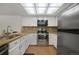 Updated kitchen boasts stainless steel appliances, granite countertops, and tiled backsplash at 18714 E Utah Cir, Aurora, CO 80017