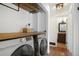 Laundry area with modern washer and dryer, plus wooden countertop and shelf at 18714 E Utah Cir, Aurora, CO 80017