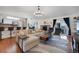Open-concept living room featuring a fireplace, modern furniture, and a smooth transition to the kitchen at 18714 E Utah Cir, Aurora, CO 80017