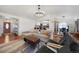 Bright, open living room with hardwood floors, modern lighting, and seamless kitchen access at 18714 E Utah Cir, Aurora, CO 80017