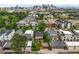 Aerial view of residential neighborhood showcasing homes, mature trees, and downtown skyline at 2131 Eliot St, Denver, CO 80211