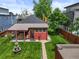 Overhead view of backyard with fountain, patio with dining, lush lawn and privacy fence at 2131 Eliot St, Denver, CO 80211