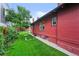 Charming red brick house with a well-manicured lawn and lush greenery in the backyard at 2131 Eliot St, Denver, CO 80211