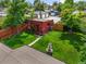 Aerial view of a lush backyard with a fountain, brick outbuilding, and well-maintained lawn at 2131 Eliot St, Denver, CO 80211
