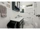 Bathroom with black vanity, mirrored medicine cabinet, and white subway tile at 2131 Eliot St, Denver, CO 80211