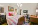 Bedroom with chandelier and desk area, and vintage bed frame at 2131 Eliot St, Denver, CO 80211