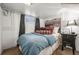 Tranquil bedroom with a comfortable bed, patterned pillows, and a charming side table at 2131 Eliot St, Denver, CO 80211