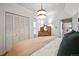 Bedroom with neutral tones, pendant light, and closet with paneled doors at 2131 Eliot St, Denver, CO 80211
