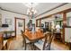 Traditional dining room featuring an elegant chandelier and open access to other rooms at 2131 Eliot St, Denver, CO 80211