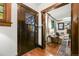 Entryway featuring a dark wood door and trim, complemented by a glimpse of the living room at 2131 Eliot St, Denver, CO 80211