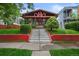 Inviting two-story home with a brick facade, landscaped yard, and prominent staircase at 2131 Eliot St, Denver, CO 80211