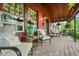 Inviting front porch with seating, lush plants, and brick flooring perfect for relaxing at 2131 Eliot St, Denver, CO 80211