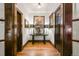 Hallway featuring hardwood floors, dark wood trim, and an antique console table at 2131 Eliot St, Denver, CO 80211