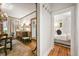 Hallway leading to bedroom and dining room with hardwood floors and warm lighting at 2131 Eliot St, Denver, CO 80211