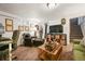 Cozy living space with eclectic decor, showcasing a comfortable leather chair and adjacent staircase at 2131 Eliot St, Denver, CO 80211