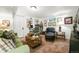 Comfortable living area features a leather chaise lounge, green couch, and an eclectic assortment of art at 2131 Eliot St, Denver, CO 80211