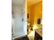 Clean bathroom with shower/tub combo and yellow walls at 1927 S Xenon St, Lakewood, CO 80228