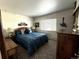 Guest bedroom with blue bedding and wood furniture at 1927 S Xenon St, Lakewood, CO 80228