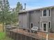 Exterior shot of the home's wooden deck with hot tub and outdoor seating area at 8851 Blue Creek Rd, Evergreen, CO 80439