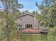 View of the backyard with a wooden deck featuring a hot tub and outdoor furniture at 8851 Blue Creek Rd, Evergreen, CO 80439