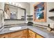 Bathroom with tiled backsplash, granite countertop and natural lighting at 8851 Blue Creek Rd, Evergreen, CO 80439