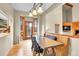 Inviting dining room with wooden floors and access to the outdoor balcony and fireplace in living room at 8851 Blue Creek Rd, Evergreen, CO 80439