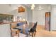 Inviting dining room with a built-in bench, wooden floors, and natural light from the windows at 8851 Blue Creek Rd, Evergreen, CO 80439
