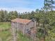 Aerial view of the home showcasing the roof, deck, and surrounding trees at 8851 Blue Creek Rd, Evergreen, CO 80439