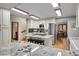 Open concept kitchen features an island with bar seating, stainless appliances, and light wood floors at 8851 Blue Creek Rd, Evergreen, CO 80439