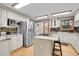 Bright kitchen featuring stainless steel appliances, island with cooktop, and granite countertops at 8851 Blue Creek Rd, Evergreen, CO 80439