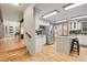 Bright kitchen with a large island, stainless steel appliances, and seamless flow to the front entrance at 8851 Blue Creek Rd, Evergreen, CO 80439