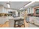 Spacious kitchen offers an island, stainless appliances, granite counters, and sleek backsplash at 8851 Blue Creek Rd, Evergreen, CO 80439