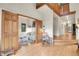 View through rustic wooden doors to a charming living room with wood floors at 8851 Blue Creek Rd, Evergreen, CO 80439
