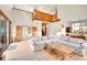 Spacious living room with high ceilings, a fireplace, wood floors, and access to the outdoor balcony at 8851 Blue Creek Rd, Evergreen, CO 80439