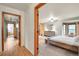 View into the main bedroom with natural light and ensuite bathroom access at 8851 Blue Creek Rd, Evergreen, CO 80439
