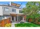 Backyard with stylish patio and seating, pergola, lush lawn, and fence line at 3885 Vrain St, Denver, CO 80212