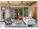 Inviting backyard patio with stylish seating, modern fire pit, pergola, and lush lawn at 3885 Vrain St, Denver, CO 80212