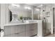 Modern bathroom with double sinks, a large mirror, and a glass-enclosed walk-in shower at 3885 Vrain St, Denver, CO 80212