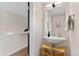 Stylish half bathroom with modern vanity, light fixture and bright neutral walls at 3885 Vrain St, Denver, CO 80212
