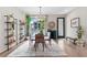 Bright dining area with a glass table, stylish chandelier, and shelving, filled with natural light at 3885 Vrain St, Denver, CO 80212