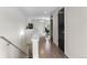 Bright hallway with hardwood floors leading to a home office and other rooms at 3885 Vrain St, Denver, CO 80212